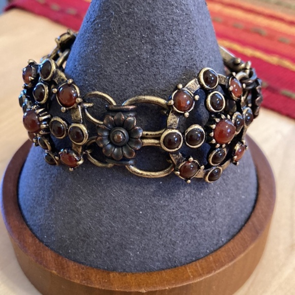 Brass tone ornate shackle bracelet with deep brown hue combo colors